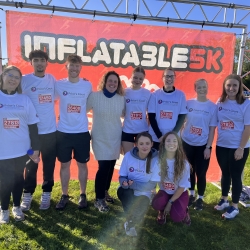 Team members bounce into inflatable fundraising challenge